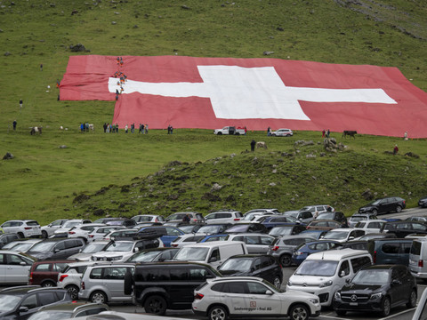 Drapeau suisse géant déchiré par le vent au pied du Säntis