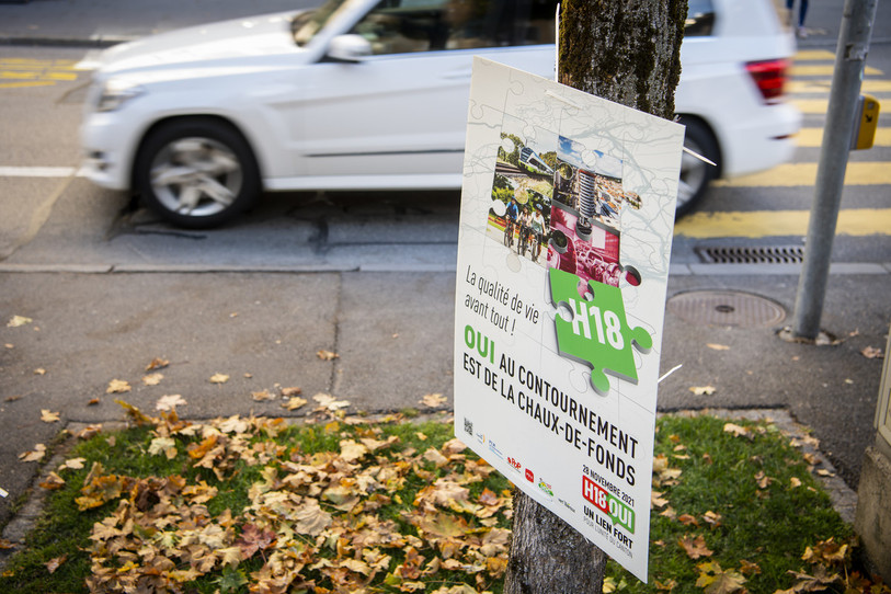 Une affiche du comité pour le contournement routier est de La Chaux-de-Fonds par la H18, soumis au vote le 28 novembre. (Photo : KEYSTONE / Jean-Christophe Bott).