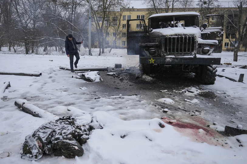 Sur cette photo AP, le corps d'un soldat repose sur la neige près d'un véhicule lance-missiles russe détruit dans la banlieue de la ville industrielle de Kharkiv (nord-est). (Photo : keystone)