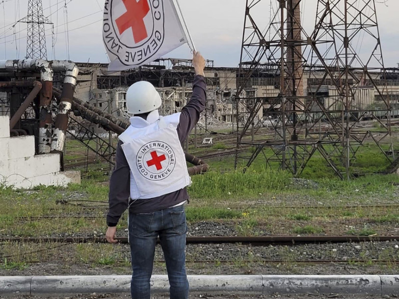 Un employé du CICR brandit un drapeau de l'organisation à l'approche de l'usine Azovstal, d'où une centaine de civils ont été évacués dimanche. (Photo : KEYSTONE/AP/CICR).