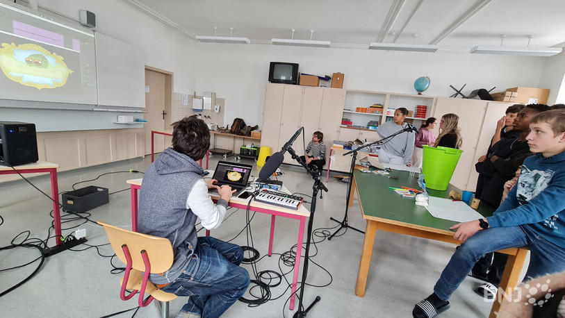 Les écoliers s'initient à la musique de film avec un professionnel du son. 