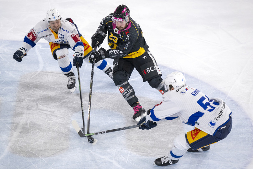 Frédérik Gauthier du HC Ajoie tente de passer entre les Zougois Jan Kovar et Dario Simion samedi soir à Porrentruy (photo : KEYSTONE/Georgios Kefalas).