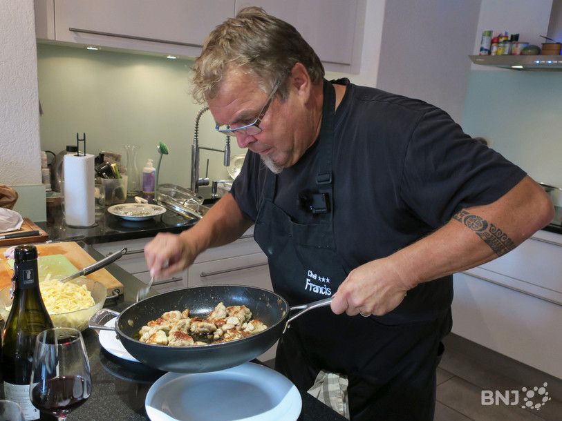 Francis Charmillot dans sa cuisine avec un tablier de chef !