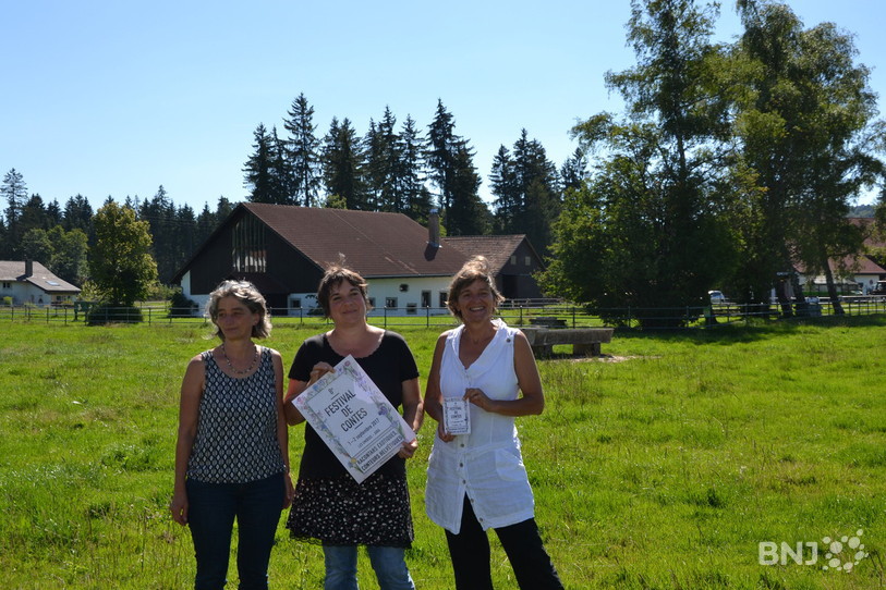 L'affiche du 8e Festival de Contes, présentée par trois des membres d'Arôme Rouge (de gauche à droite : Jocelyne Teuscher, Geneviève Boillat et Sabine Clémence). 