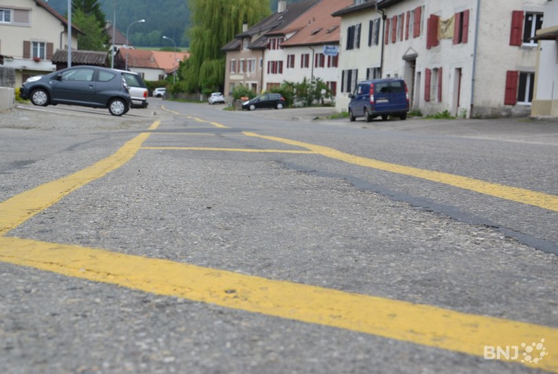 La route cantonale qui traverse le Grand-Savagnier est bordée d'un marquage jaune qui figure un trottoir.