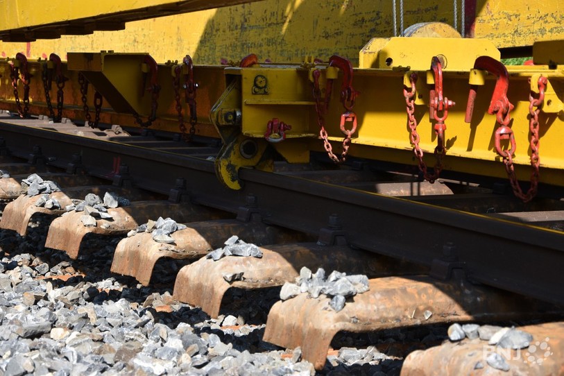 Les rails sont soulevés à l’aide d’une machine.