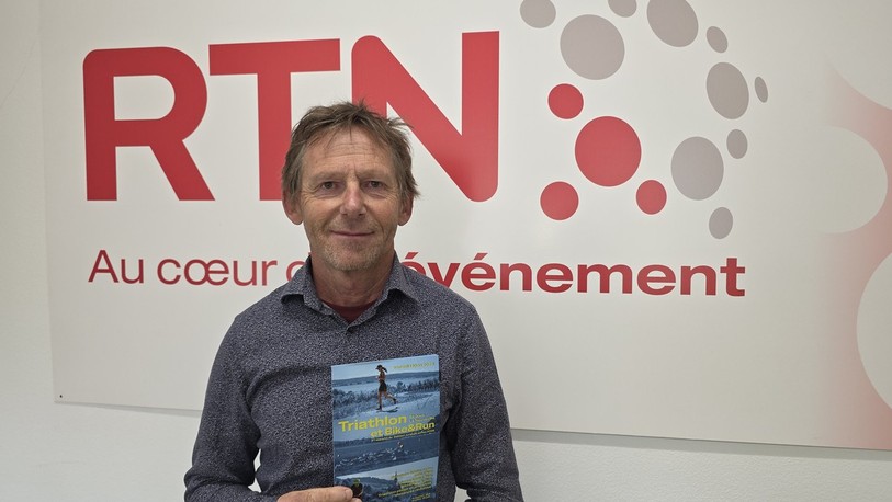 Richard Mamie avec l'affiche du triathlon de la Neuveville.