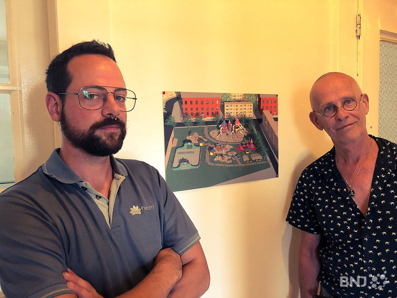 Gaëtan Parel, responsable des opérations de Lactell (à gauche) et le fondateur Blaise Parel posent devant la photo d'une place de jeu construite à Moscou.